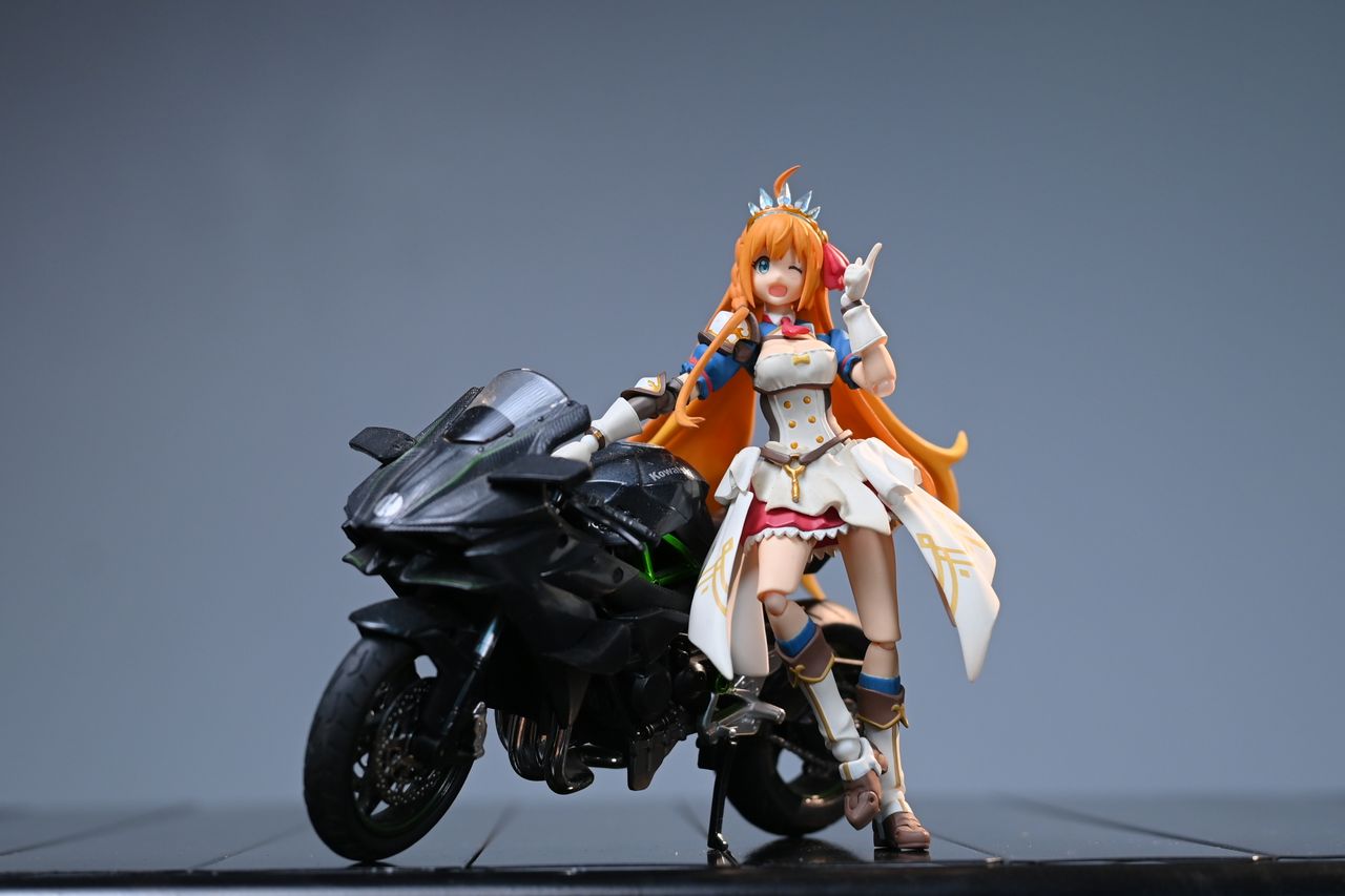 Anime figure posing with a sleek black motorcycle, perfect for character and toy enthusiasts.